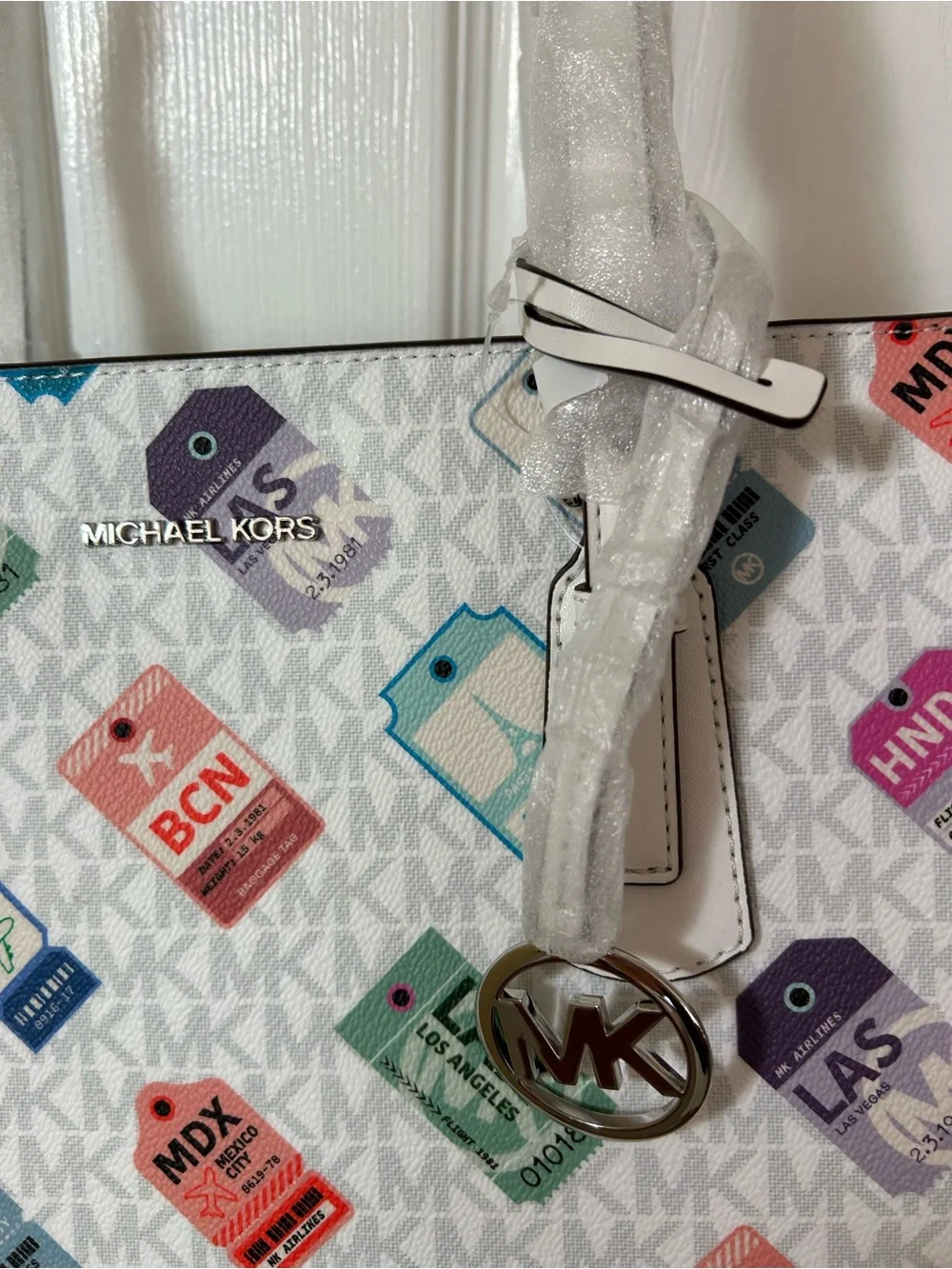 Michael Kors White Tote with Multicolor Luggage Tag Pattern